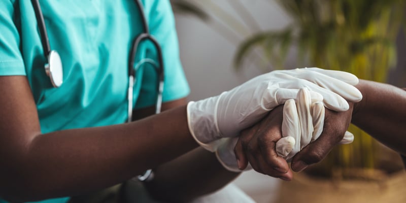 Close up shot of a doctor holding the hand of a patient