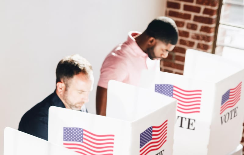 Two people at voting booths