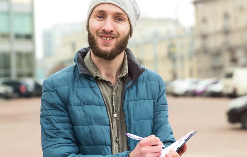 Young man holding a clipboard for volunteering